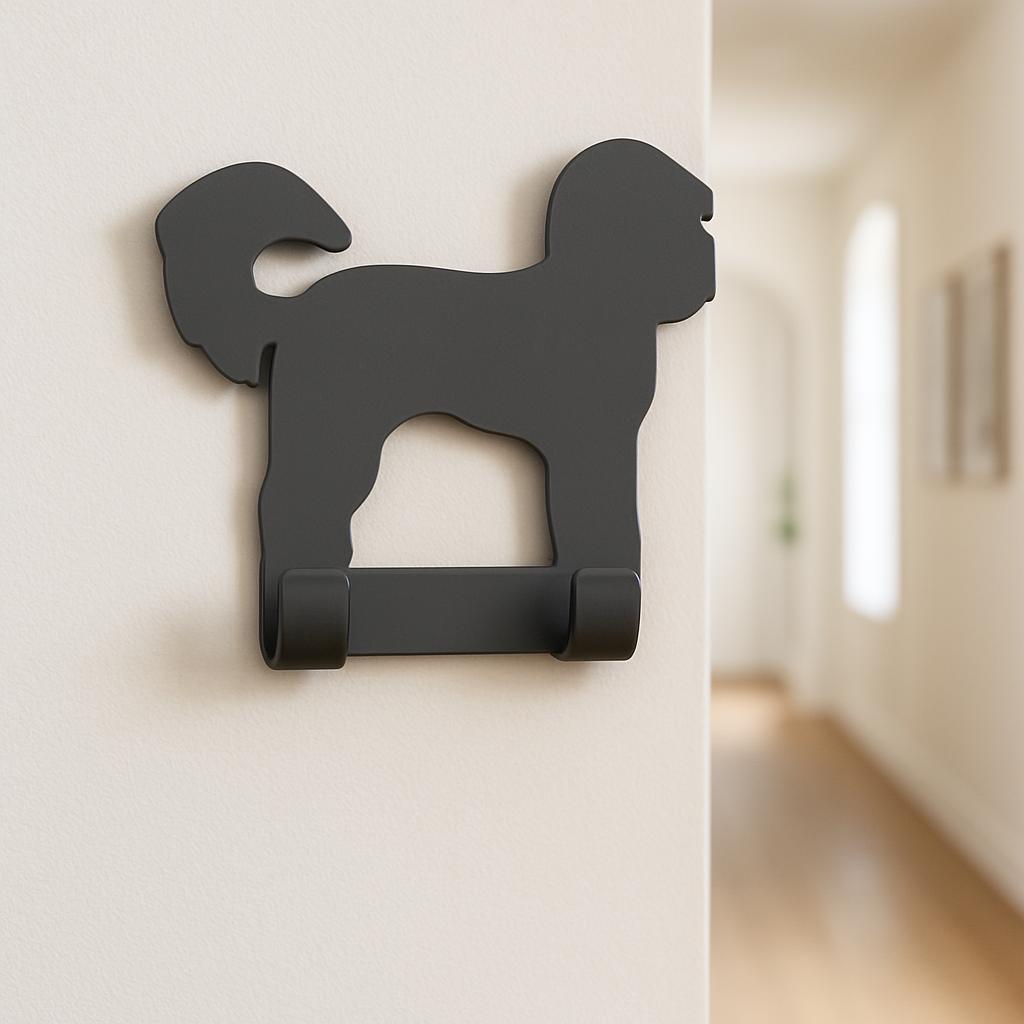 Black dog-shaped wall hook on a white wall