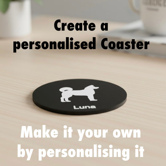 Akita 3D Printed Dog Coaster. Black coaster with a white Akita dog and 'Luna' text on a wooden surface, with text overlay promoting personalization.