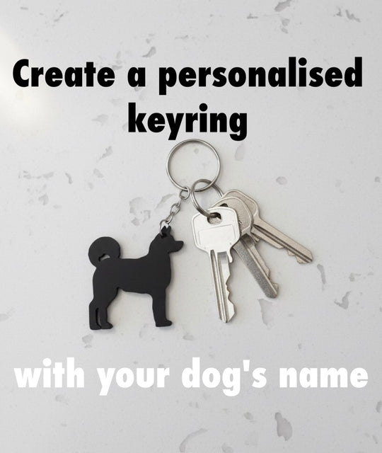 Akita 3D Printed Dog Keyring. Akita Keyring and keys on a light gray background with text about creating a personalised keyring with a dog's name.