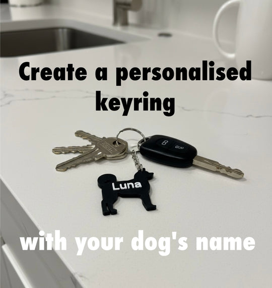 Akita 3D Printed Dog Keyring. Akita Keyring and keys on a kitchen counter with text about creating a personalised keyring with a dog's name.