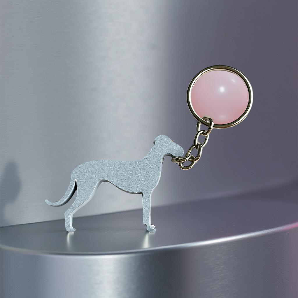Dog-shaped keychain with a pink round tag on a metallic surface
