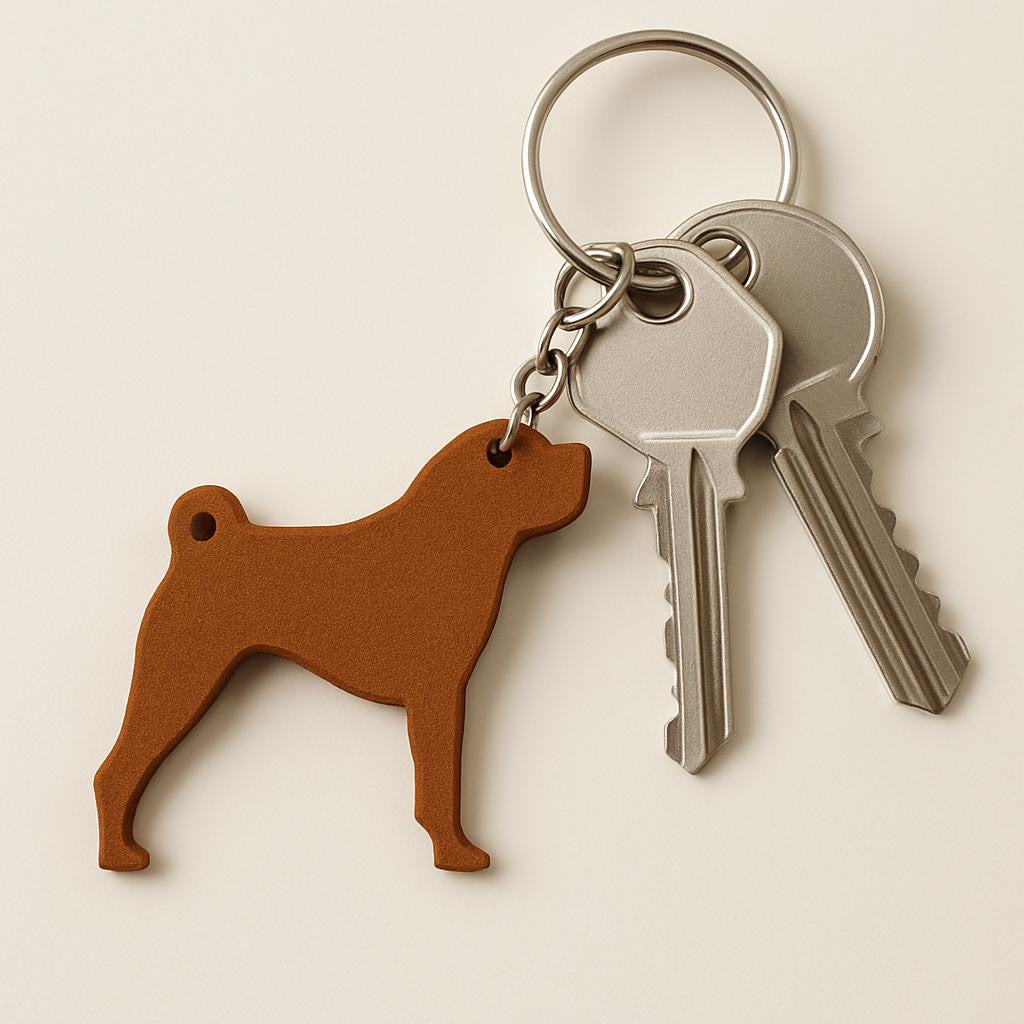 Keychain with dog-shaped tag and two keys on a beige background