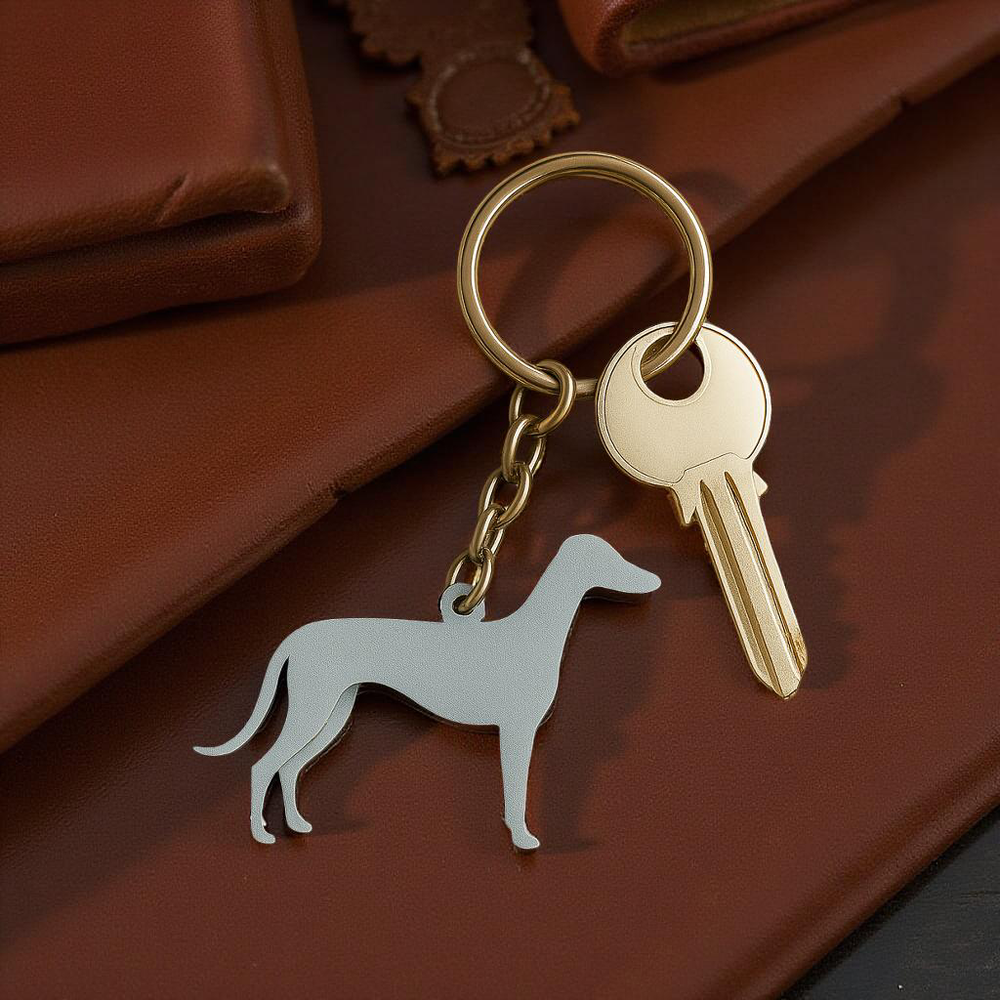 Keychain with a dog-shaped charm and a key on a brown surface