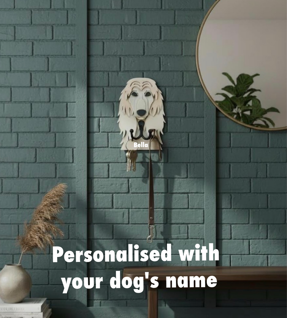 Personalised Afghan Hound dog face wall hook with name Bella, used for hanging keys and dog lead on a green brick wall in a home