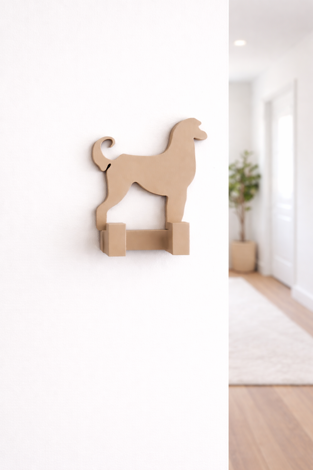 3D printed Afghan Hound dog wall hook mounted on a white hallway wall in a bright home interior, decorative pet lead holder and organiser.