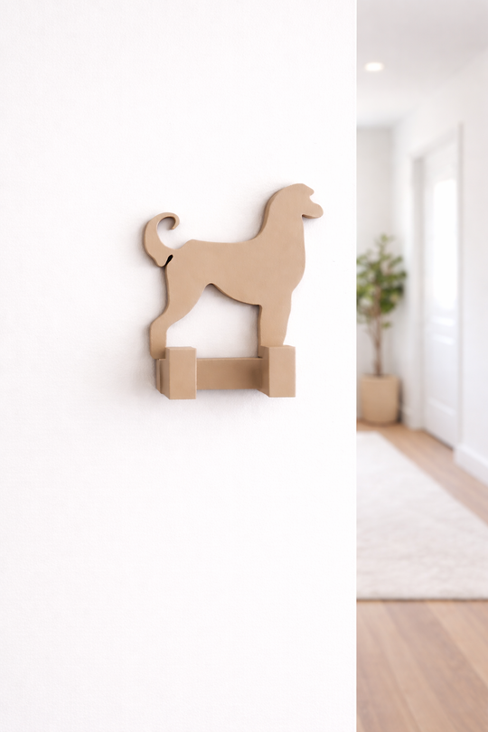 3D printed Afghan Hound dog wall hook mounted on a white hallway wall in a bright home interior, decorative pet lead holder and organiser.