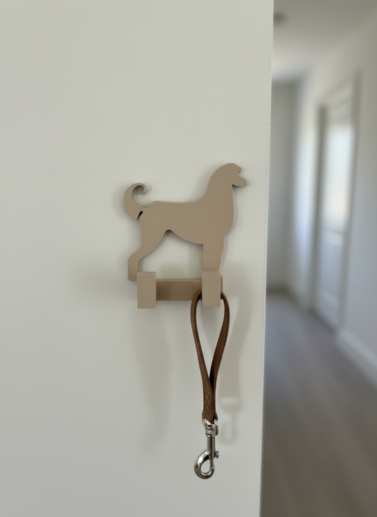 3D printed Afghan Hound dog wall hook mounted on a white hallway wall holding a dog leash, decorative pet organiser for home entryway.