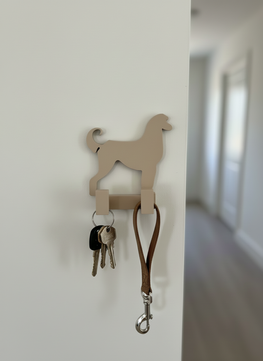 3D printed Afghan Hound dog wall hook mounted on a white hallway wall holding keys and a dog leash, decorative pet organiser for home entryway.