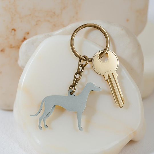 Keychain with dog charm and key on a shell