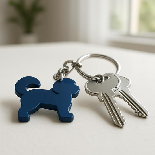 Keychain with a blue dog-shaped tag and two keys on a light surface.